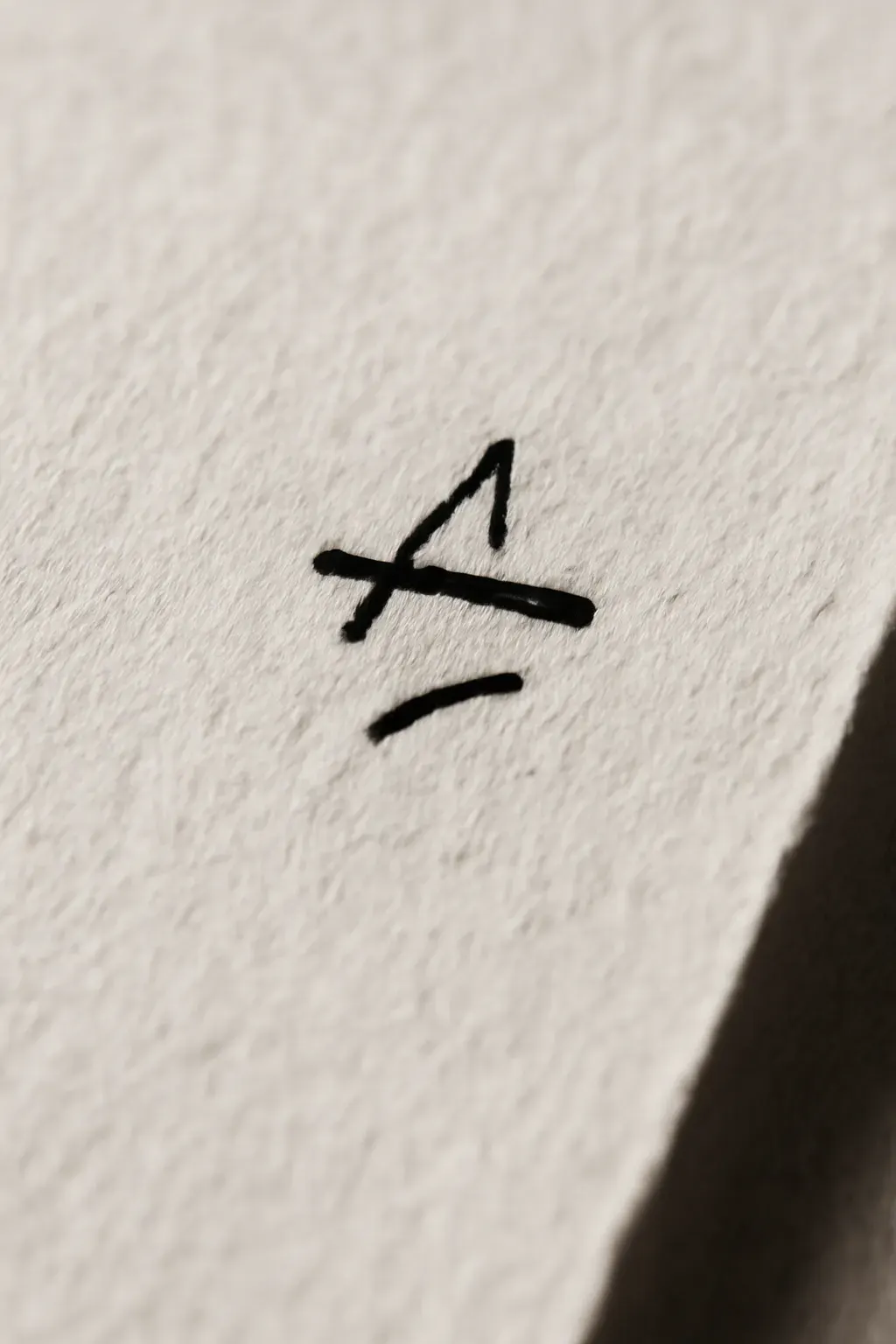 A duotone close crop of a marked-up manuscript page corner.