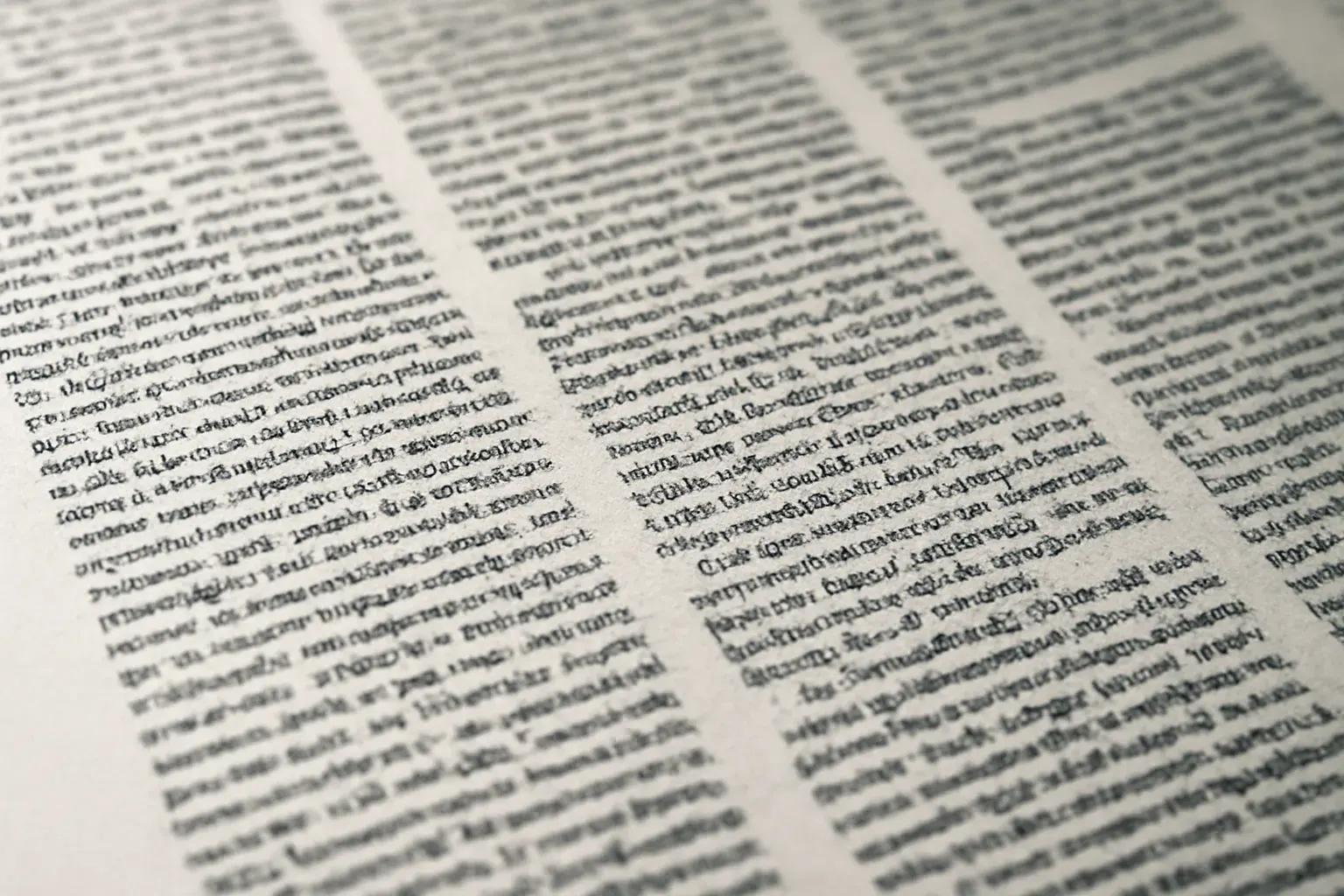 A duotone close crop of typeset column proofs, ink on paper.